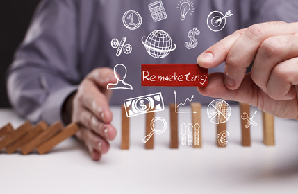 Business, Technology, Internet and network concept. Young businessman shows the word: Remarketing